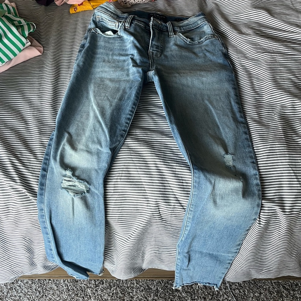 Womens jeans. Bought with distressing on fronts and on bottoms.